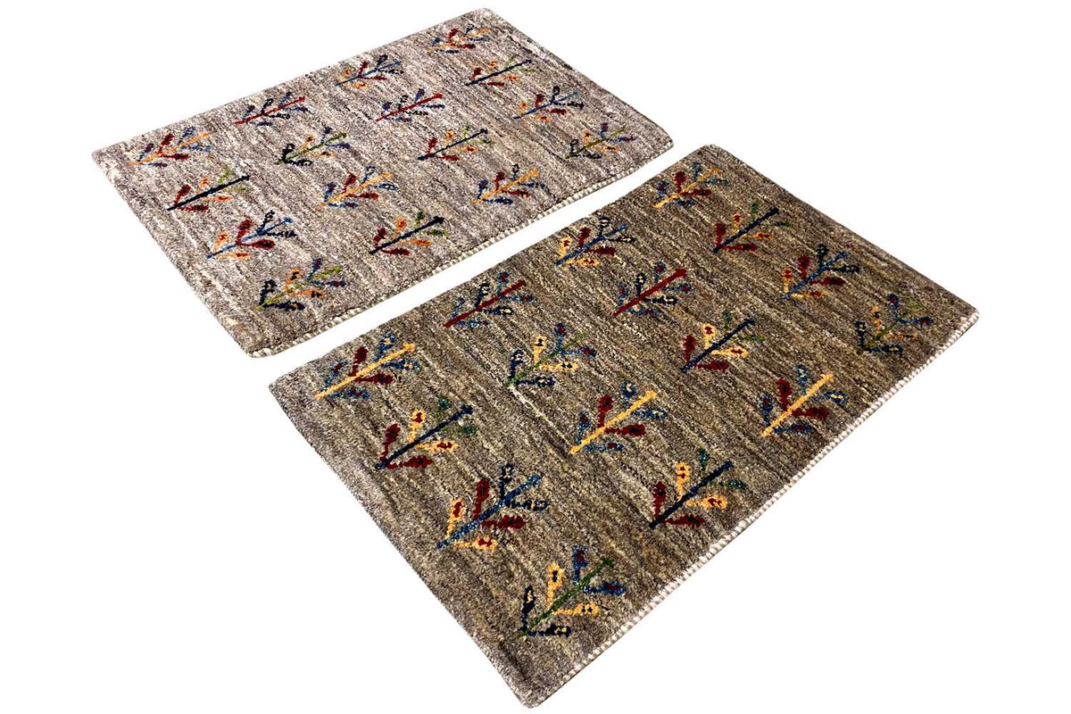 Gabbeh rug 40x60 cm, two pieces viewed from above at an angle with a colorful vine pattern