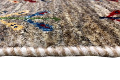 Gabbeh rug 40x60 cm close-up: fringed edge, beige pile, and colorful pattern
