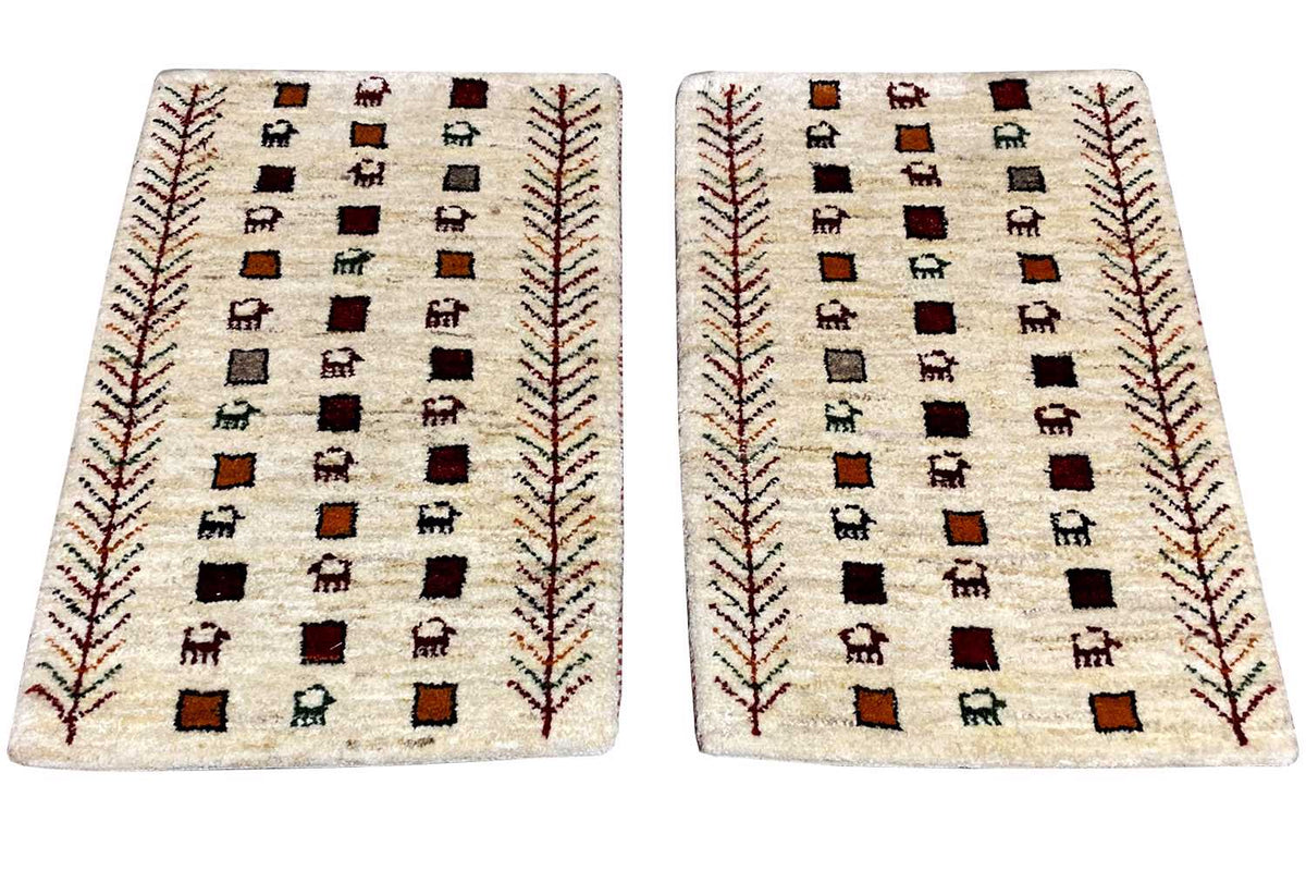 Gabbeh rug, cream-colored with a geometric square pattern featuring figures and red decorative lines