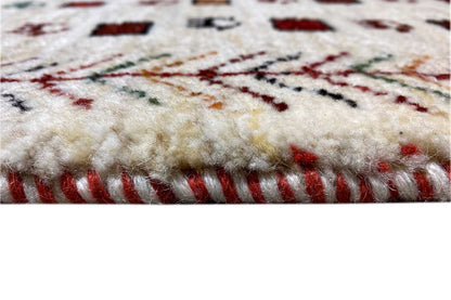 Gabbeh rug, cream-colored pile with red fringes and a colorful embroidered pattern
