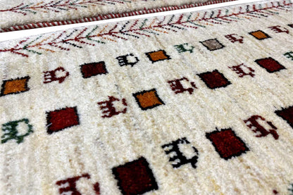 Gabbeh rug, cream-colored pile with colorful squares and red decorative lines