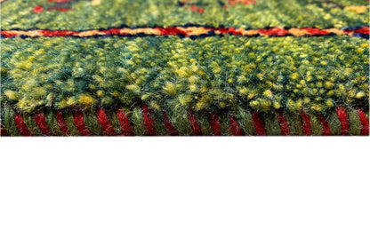 Gabbeh rug, detail of the pile surface in green/yellow with a red-bordered edge