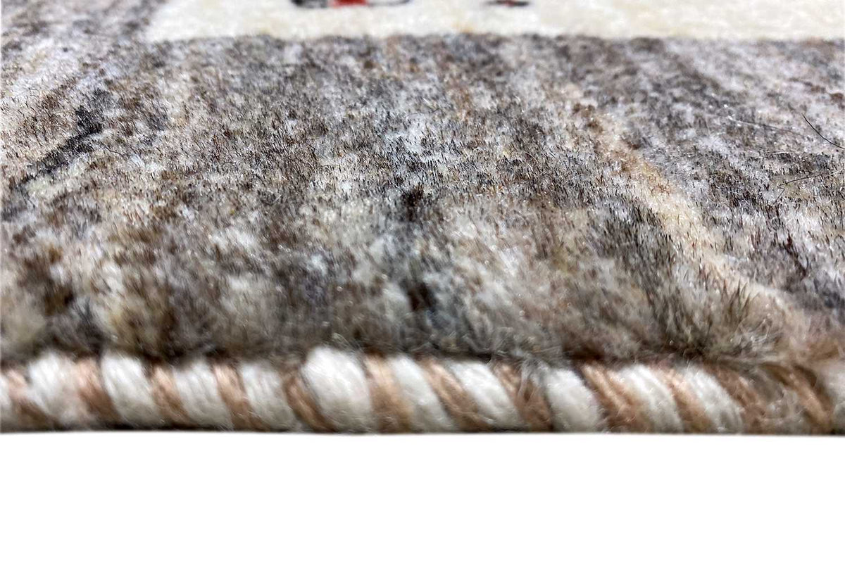 Carpet edge with braided fringe trim and gray-beige wool pile
