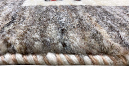 Carpet edge with braided fringe trim and gray-beige wool pile