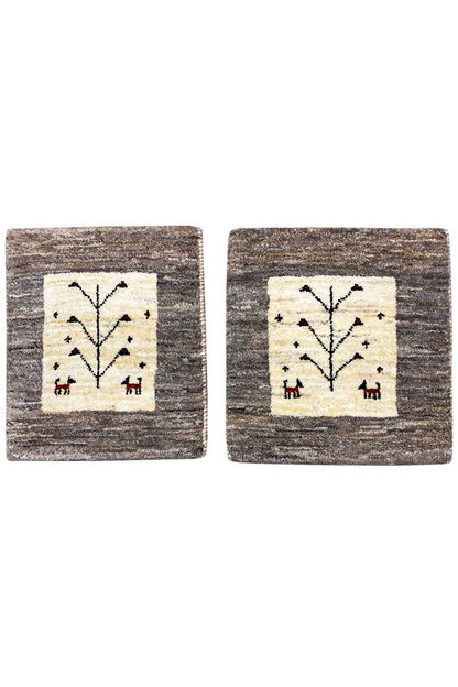 Square Gabbeh rug with a beige central panel and a black tree motif on a gray background