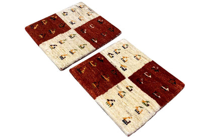 Rectangular Gabbeh rug, reddish-brown and cream-colored areas, with decorative elements