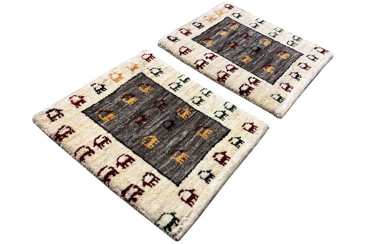 Gabbeh rug 43x37 cm, square, shown at an angle with animal patterns in the dark center