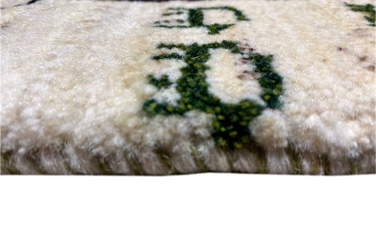 Gabbeh rug 43x37 cm, close-up: beige pile with colorful floral/plant motifs