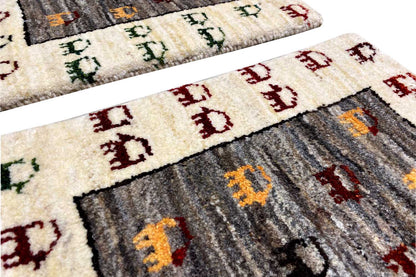 Gabbeh rug 43x37 cm, detail view: beige border with dark fields and animal patterns