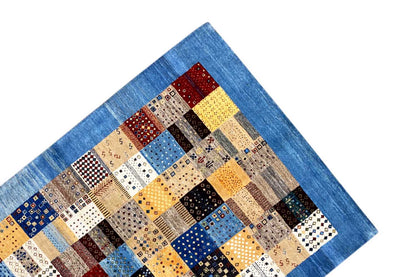 Geometric Gabbeh rug, detail of the blue border with patchwork tiles in blue and beige
