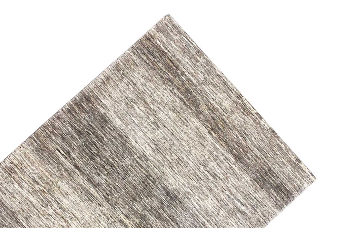Gabbeh rug, corner in close-up, mottled gray-beige with a clean edge