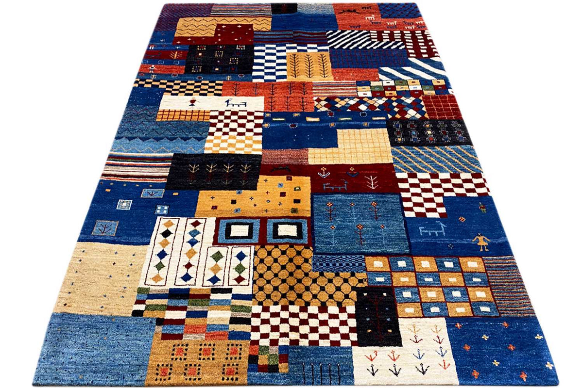 Gabbeh rug with a colorful patchwork design, predominantly blue with red and beige