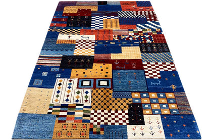 Gabbeh rug with a colorful patchwork design, predominantly blue with red and beige