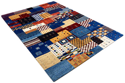 Gabbeh rug with a square patchwork pattern in blue, red, yellow, and beige