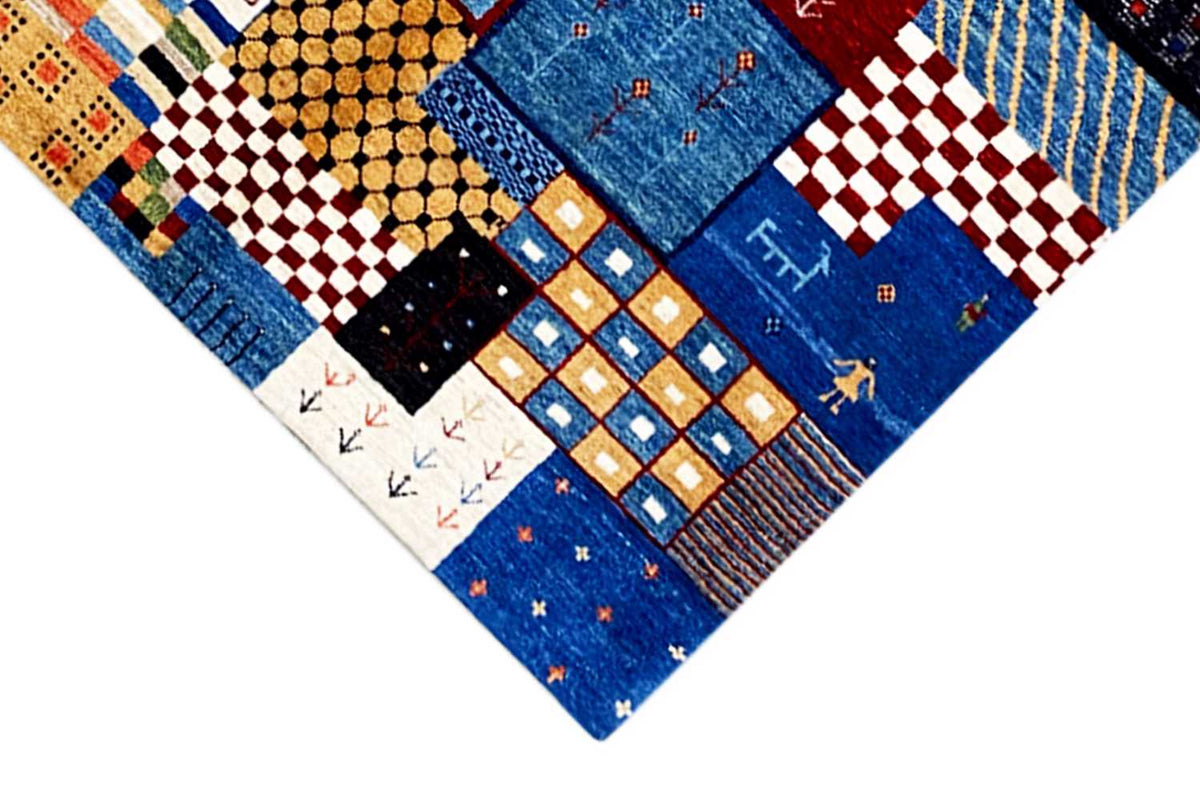 Detail of a Gabbeh rug with geometric squares and lines, blue predominates