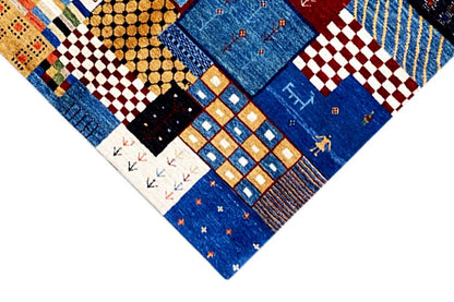 Detail of a Gabbeh rug with geometric squares and lines, blue predominates