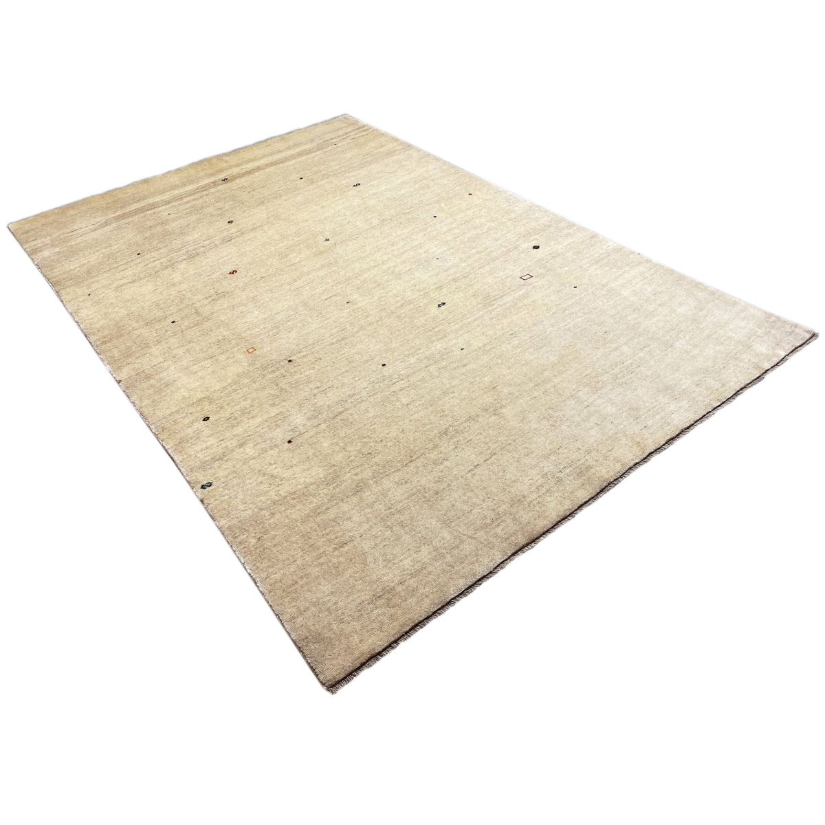 Beige Gabbeh rug, photographed diagonally, with small colorful pattern dots.