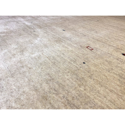 Close-up: beige carpet surface with a fine woven texture and colorful dots.