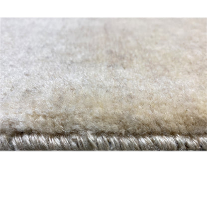 Close-up of the pile edge: beige Gabbeh rug with short pile.