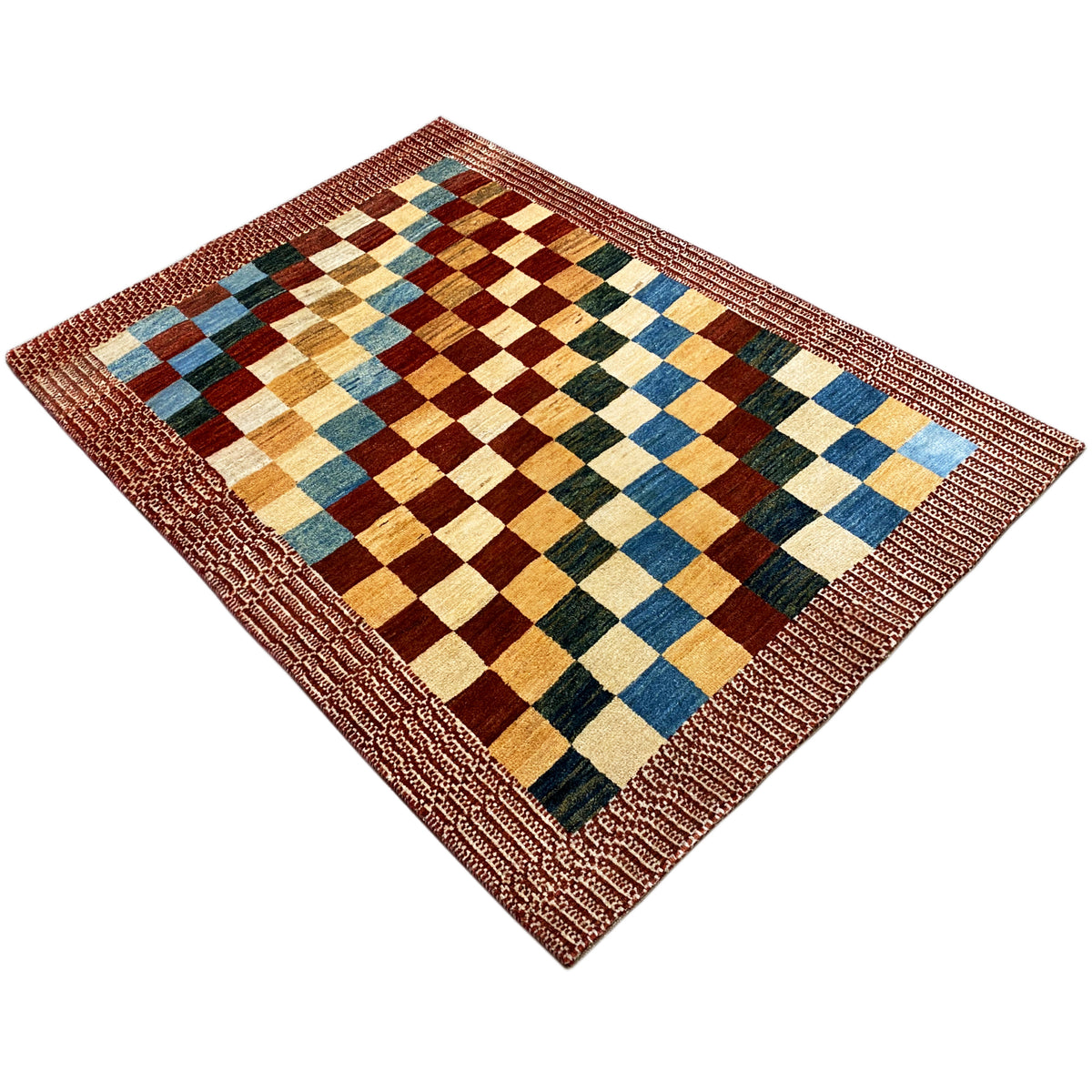 Gabbeh rug laid at an angle, multicolored diamonds in a checkered pattern with a reddish-brown border
