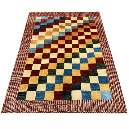 Gabbeh rug laid flat with a wide decorative stitched border and multicolored square check pattern