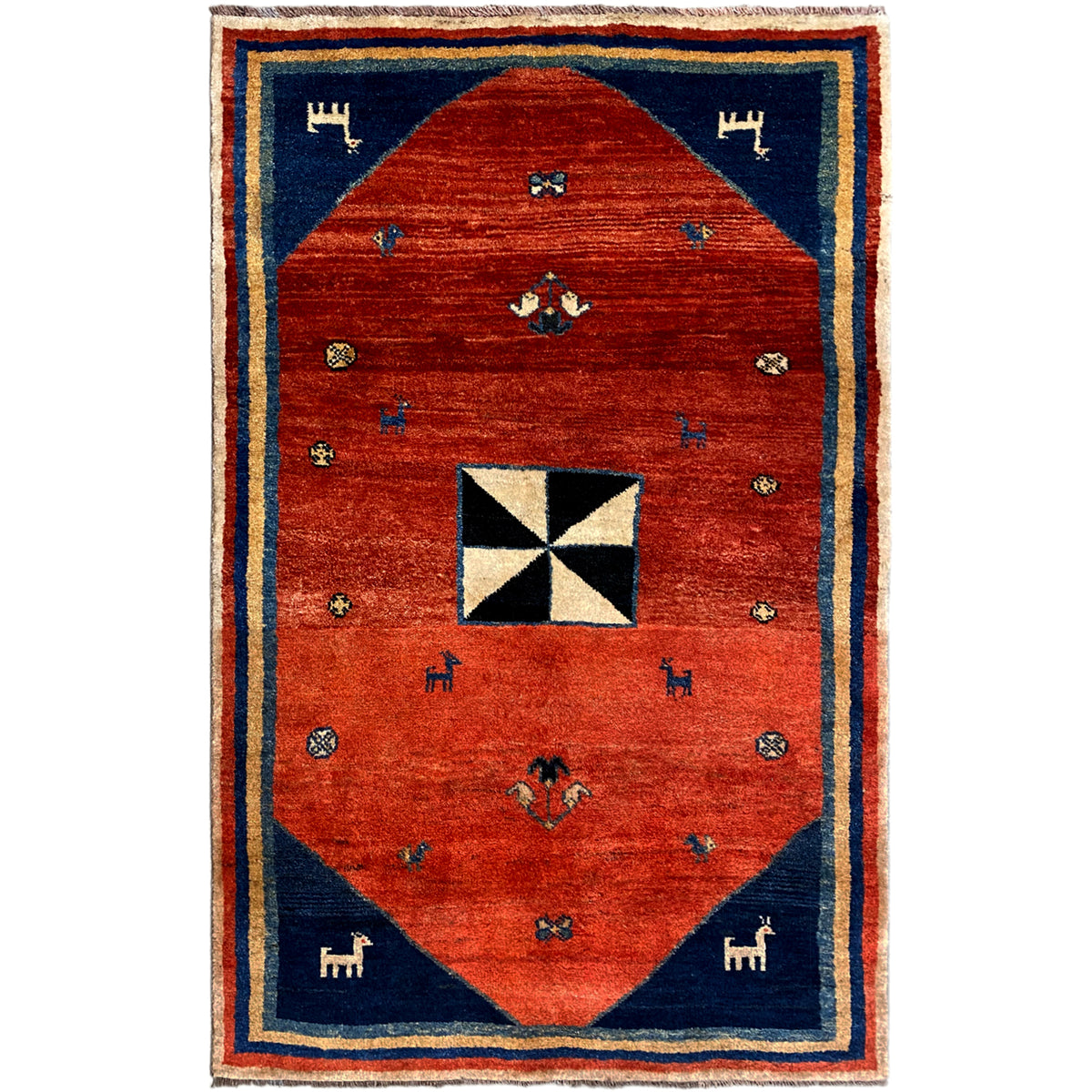 Gabbeh rug with red center, blue border, and white-and-black octagonal motif
