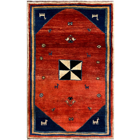 Gabbeh rug with red center, blue border, and white-and-black octagonal motif