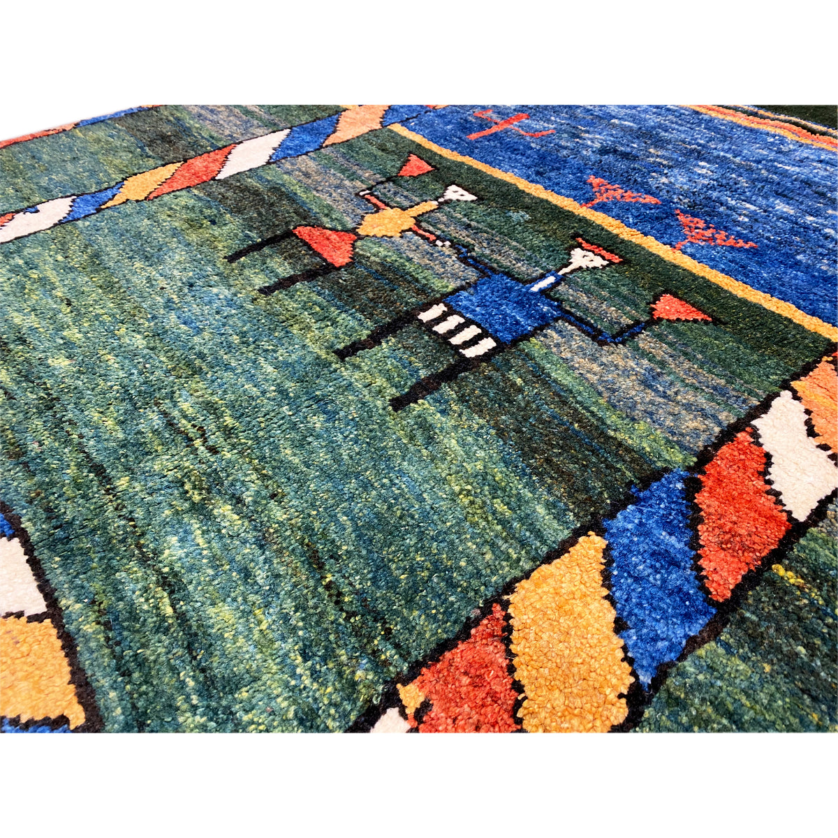 Gabbeh rug detail view: dense pile with colorful motifs and stripes