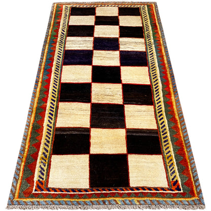 Gabbeh rug in a straight design, diamond pattern in cream, black, and blue with a colorful border
