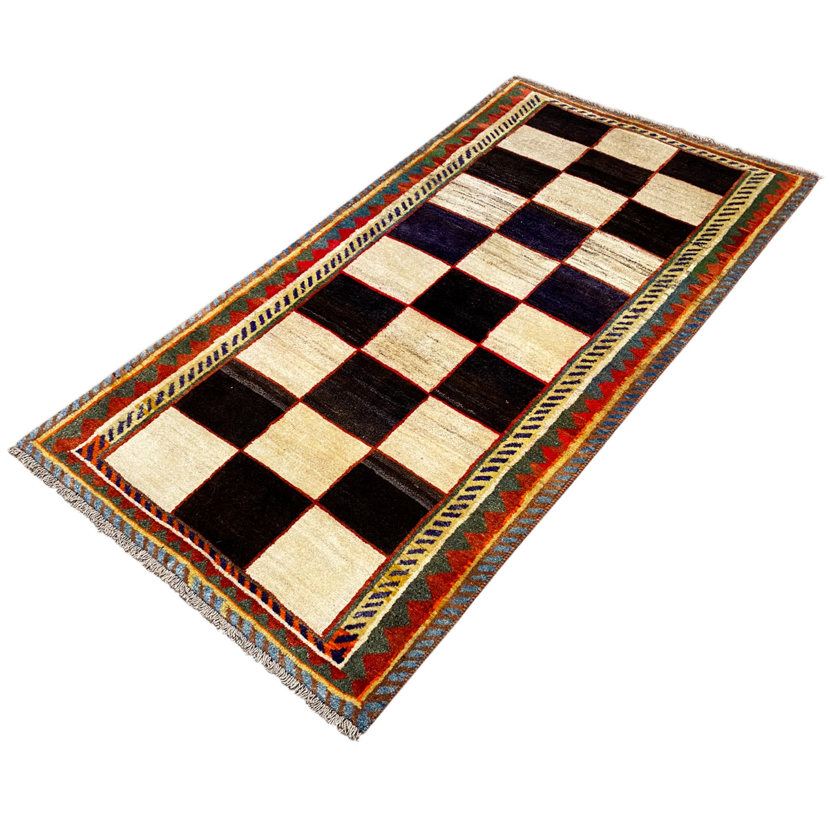 Gabbeh rug shown at an angle, diamond pattern with cream and black fields and blue accents