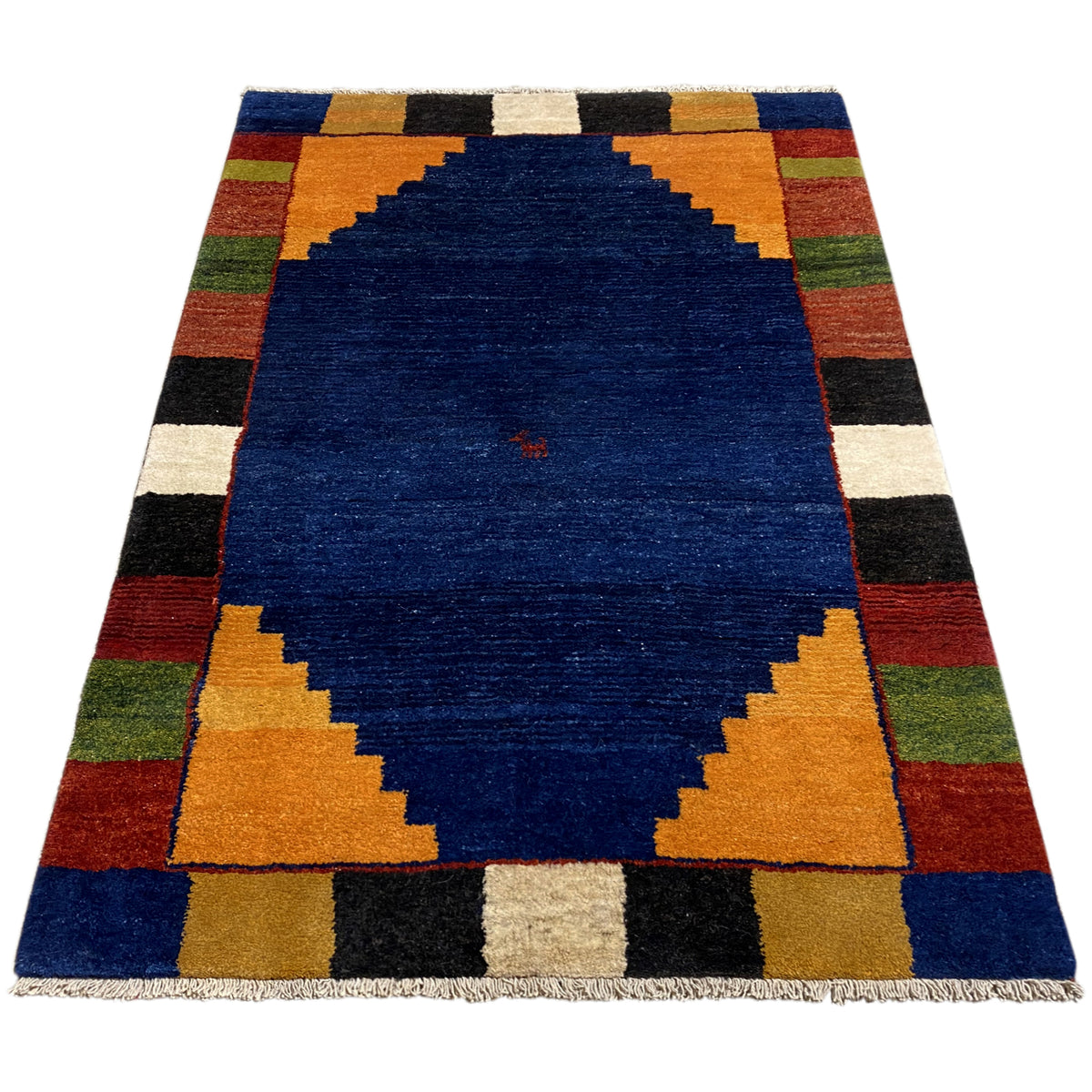 Rectangular rug with a blue center and a checked border in orange, green, and black.