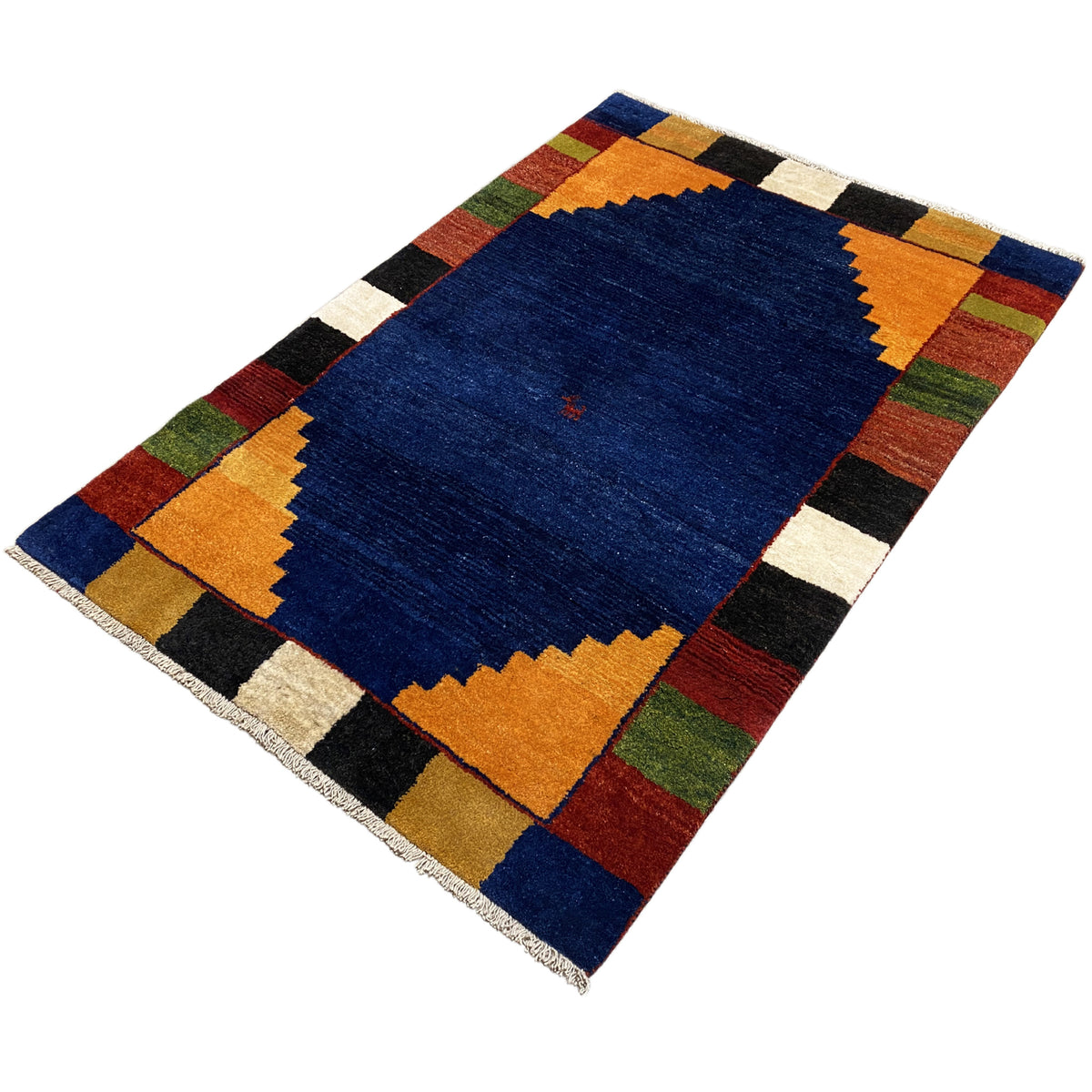 Rug with a blue area, orange zigzags, and a multicolored block pattern.