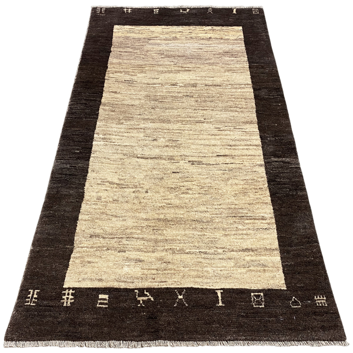 Rectangular rug with a long beige central stripe and a dark border trim