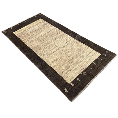 Rectangular rug in landscape orientation: beige interior, dark border