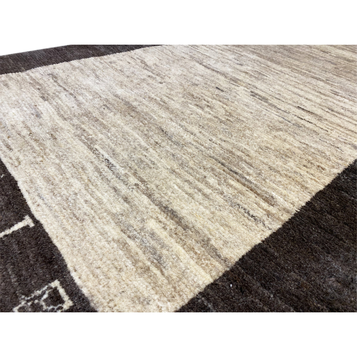 Carpet fiber detail: beige center field with a fine striped texture and dark border