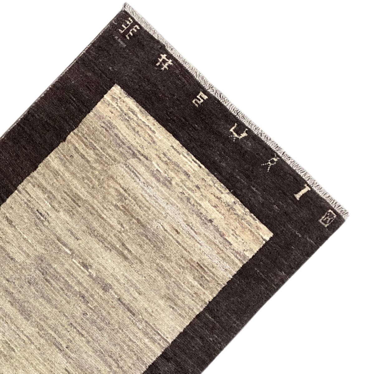 Rug corner: beige interior, dark border with small symbolic elements