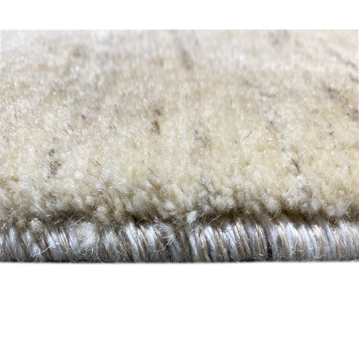 Gabbeh rug detail: dense pile in light beige