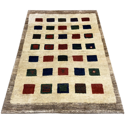 Gabbeh rug, woven pile with geometric squares in blue, red, green, and beige
