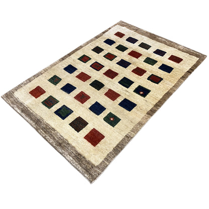 Gabbeh rug with geometric patchwork of squares in red, blue, and green, beige