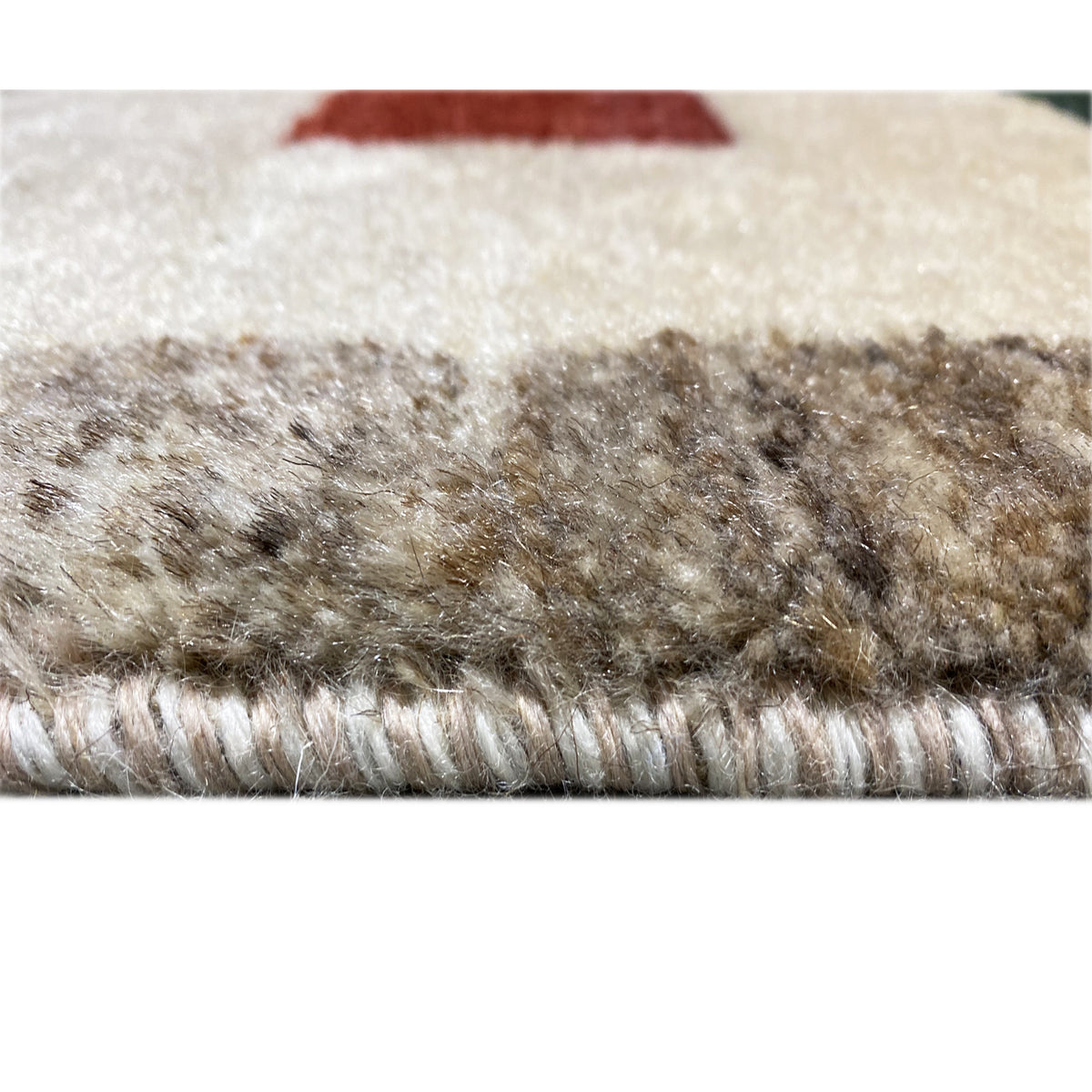 Gabbeh rug close-up of the pile: short, mottled fibers in beige and brown tones