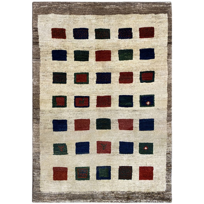 Gabbeh rug with a square pattern in blue, red, green, and beige, rectangular