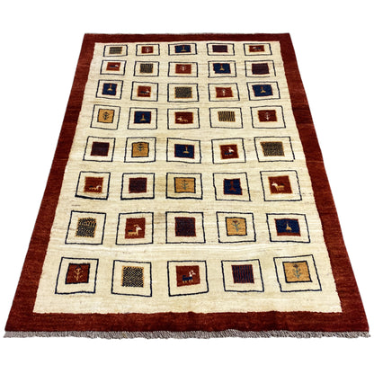 Gabbeh rug with a square pattern, cream-colored background, reddish-brown border, and short fringes