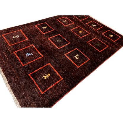 Gabbeh rug, detail: brown pile with red squares and woven-in animal motifs