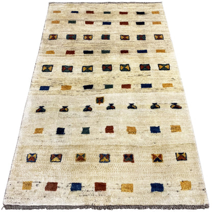 Gabbeh rug, diagonal: beige pile with geometric rows in blue, red, and ochre