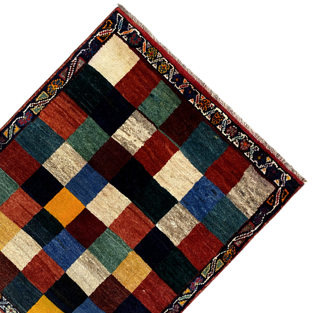 Gabbeh rug corner: border strips and checked pattern in red, blue, green, and beige