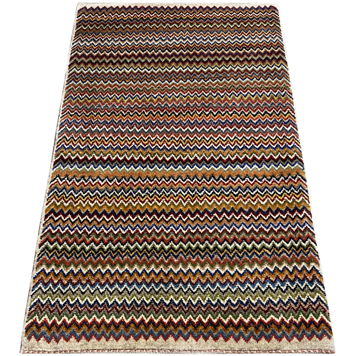 Gabbeh rug 130x75 cm, wide multicolored zigzag pattern with a bound edge.