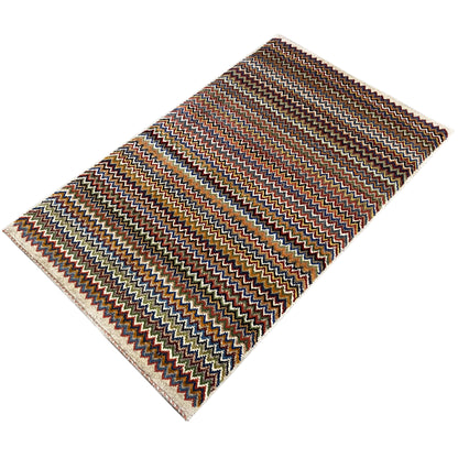 Gabbeh rug 130x75 cm with a zigzag pattern in brown, blue, and beige, finished edges.