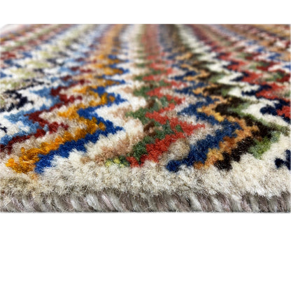 Gabbeh rug 130x75 cm close-up: multicolored pattern with short pile along the edge.