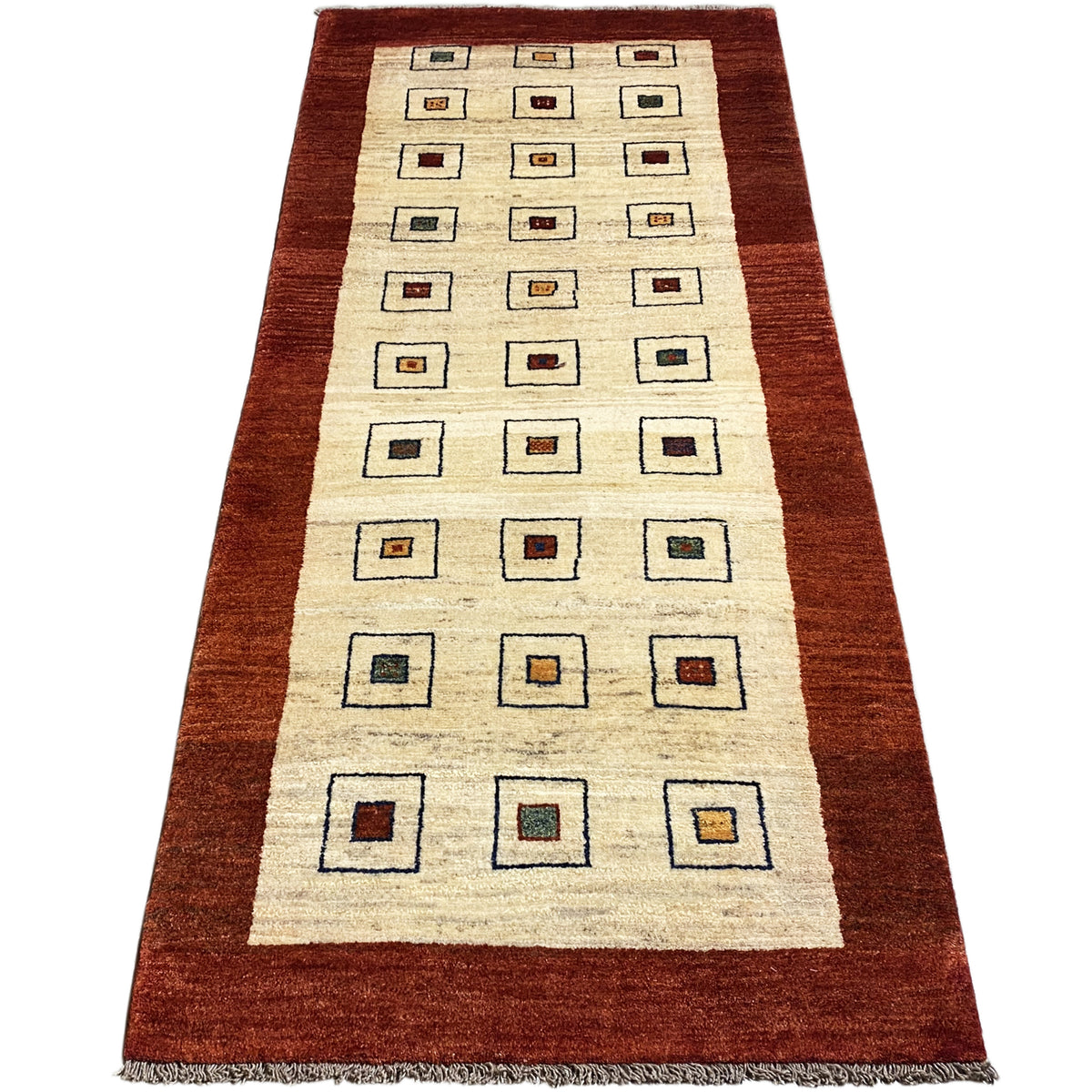 Runner rug with a cream-colored base and square motifs, brown border