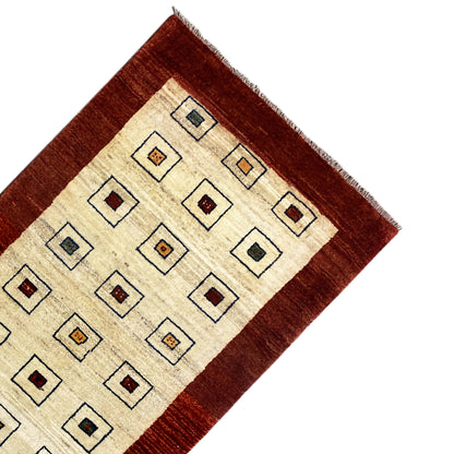 Carpet runner corner with a brown border and cream-colored field featuring square shapes